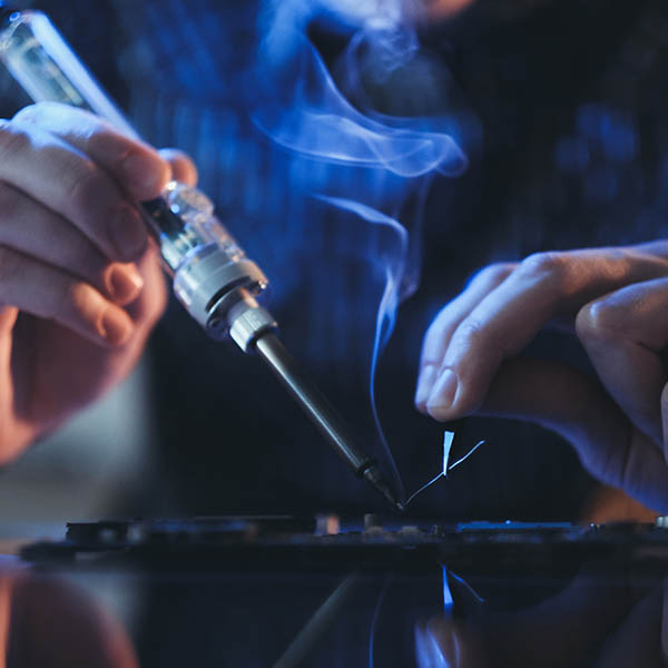Fume Control Worker soldering electronic equipment