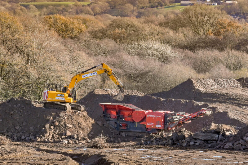 Pontypridd,,Wales,-,November,2020:,Excavator,Loading,Earth,And,Rubble Soil Fertility Analysis. Female agronomist taking soil sample.