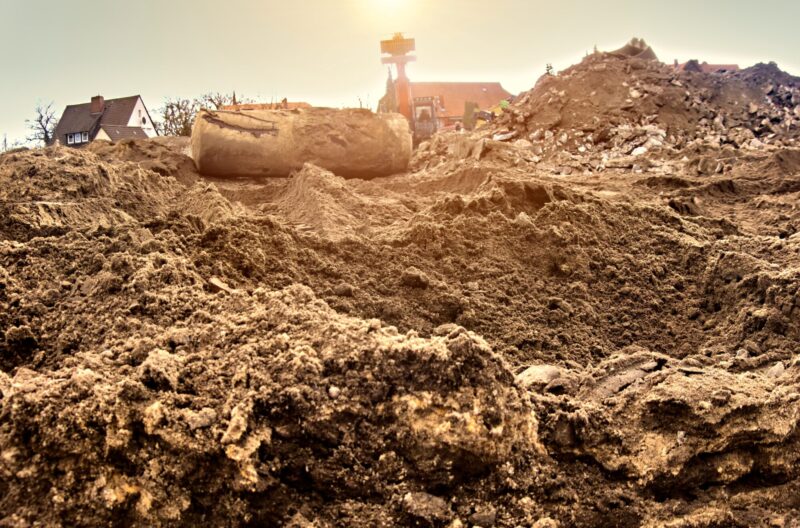 Ground,View,Over,The,Sandy,Subgrade,Of,A,Construction,Site A farmer on a potato field working with a hoe