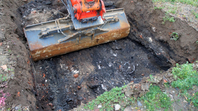 Garbage,Found,When,Excavating,The,Excavation,Pit,From,A,Former farmer holding soil in cupped hands in sun light